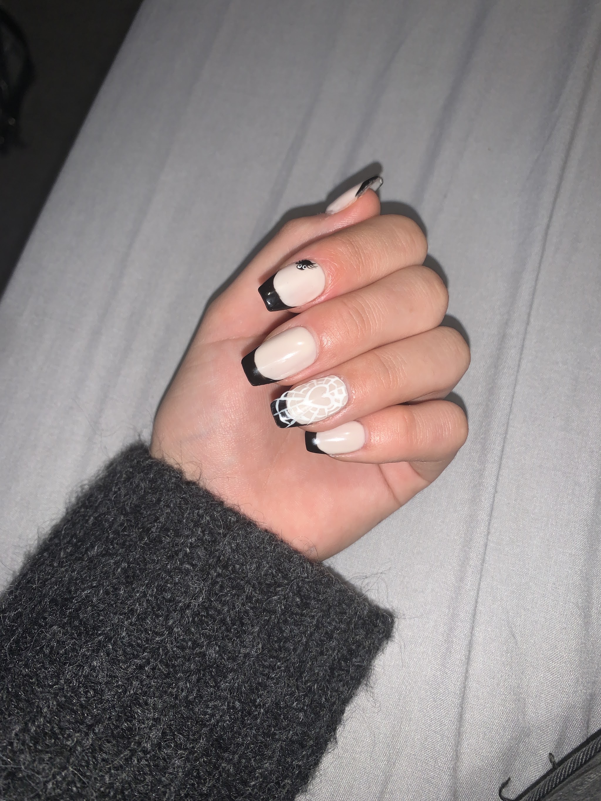 Nude nails with black French tips and nail art