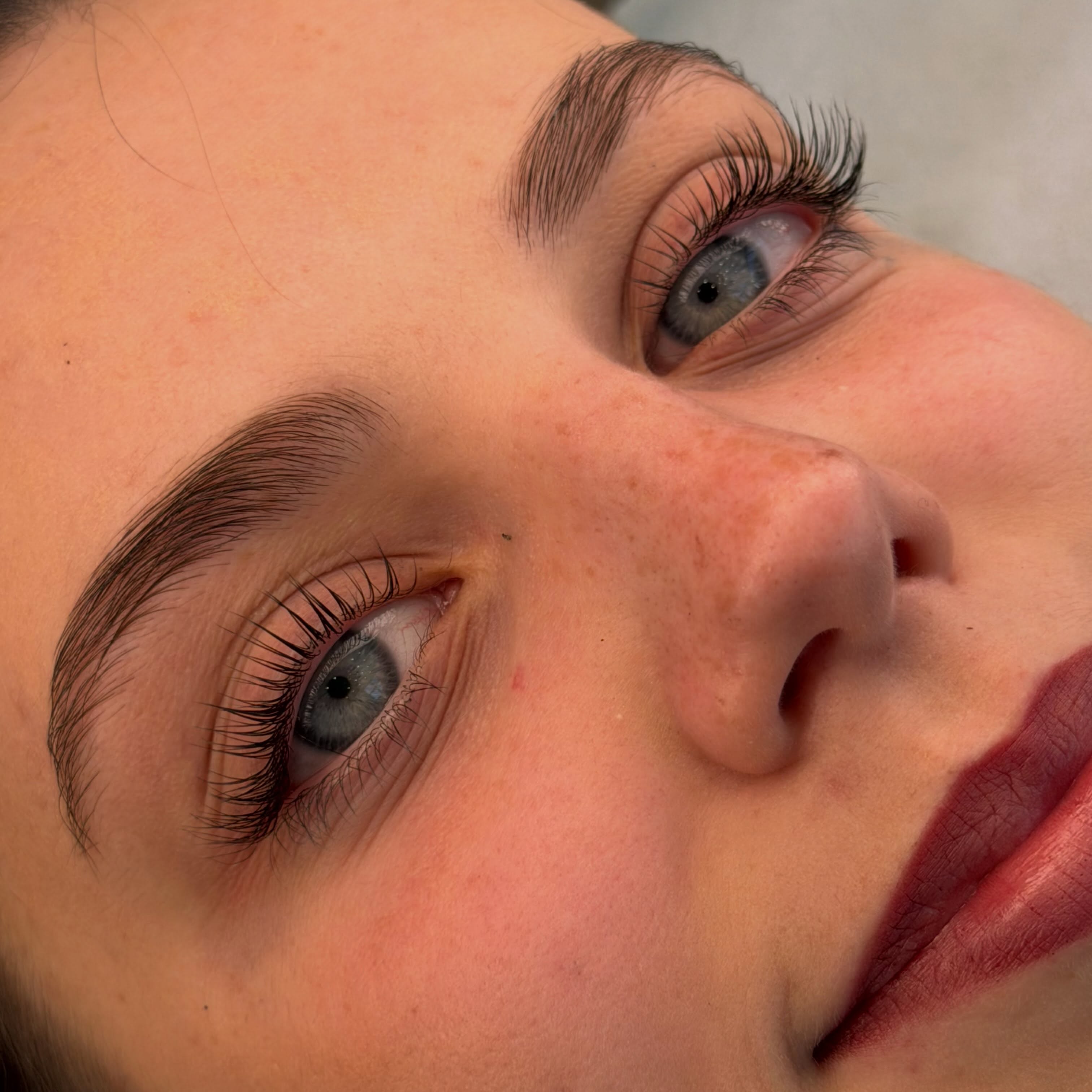 Lash lift and brow tint result on blue eyes