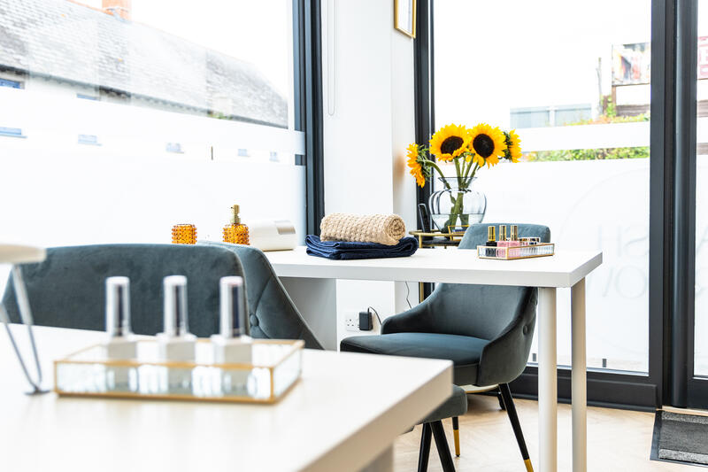 Manicure tables by the front window with sunflowers
